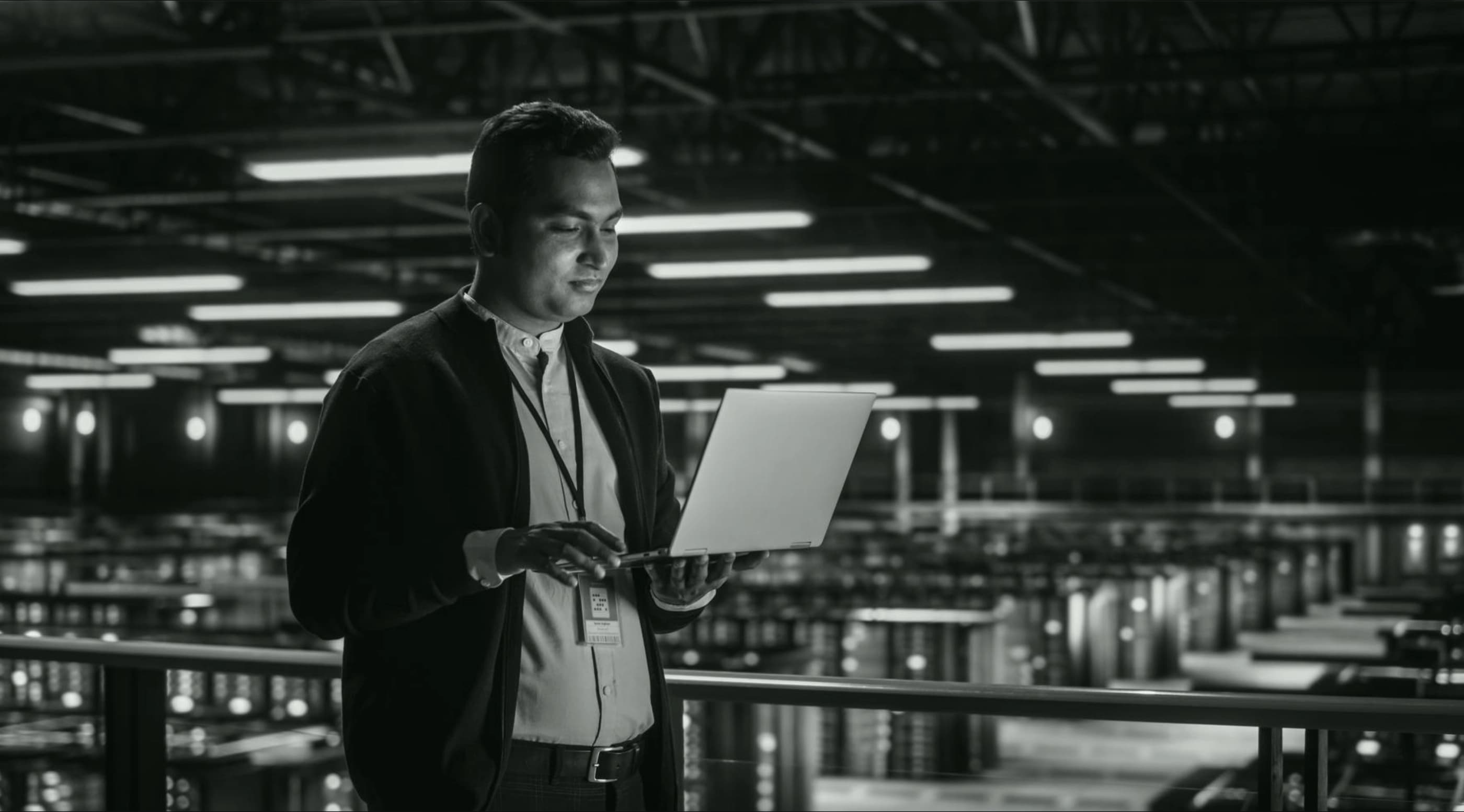 Engineer holding a laptop inside a datacenter